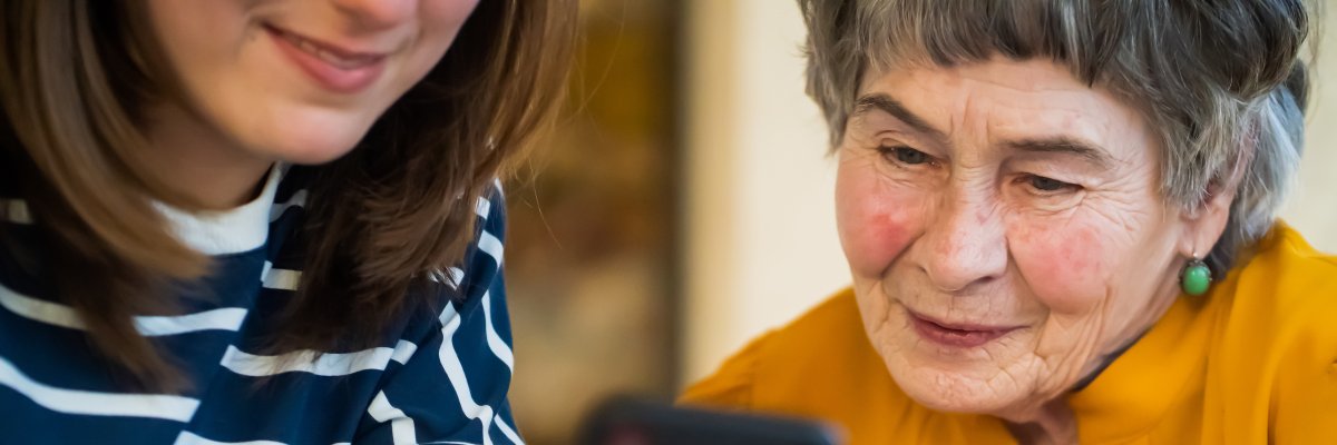 Girl helps her grandmother with mobile phone. Girl helps her grandmother with mobile phone.
